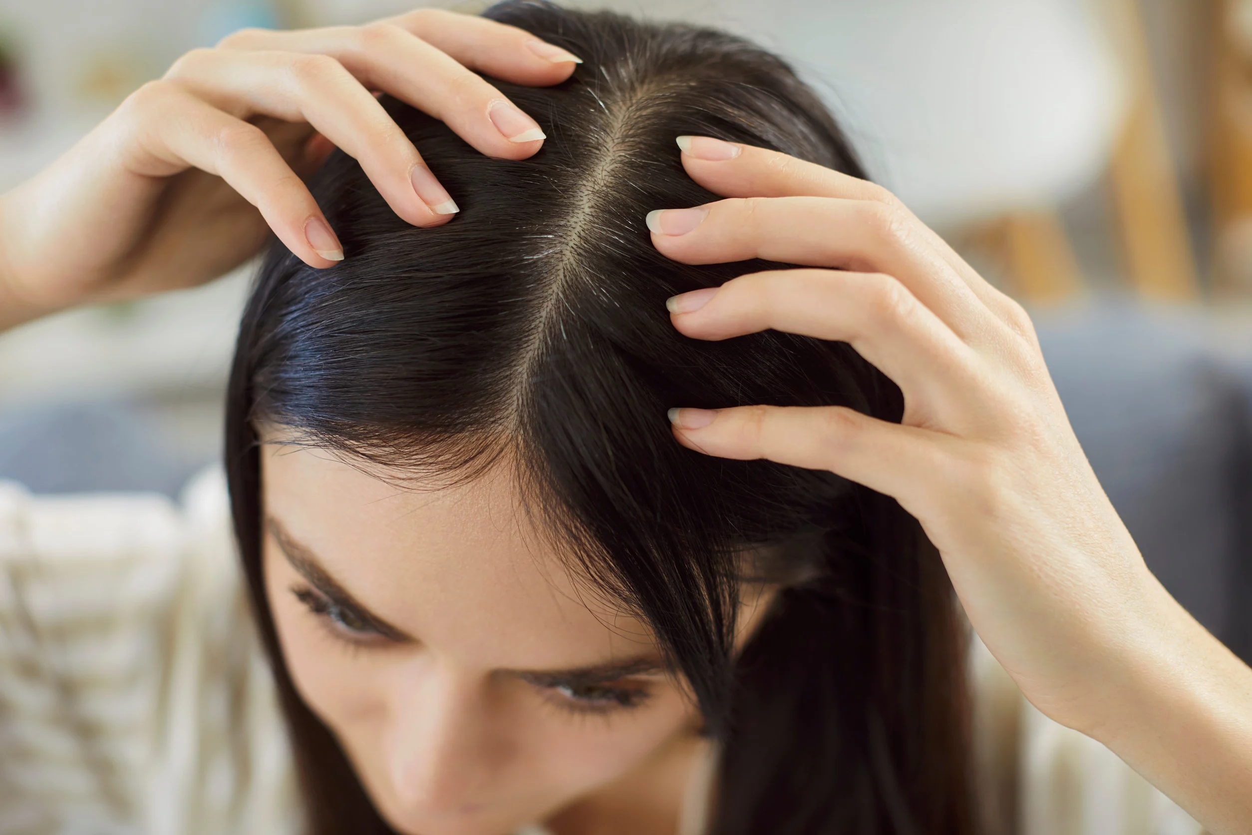 Una donna si controlla la radice dei capelli